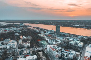 RIga rooftop view panorama at sunset with urban architectures and Daugava River.
