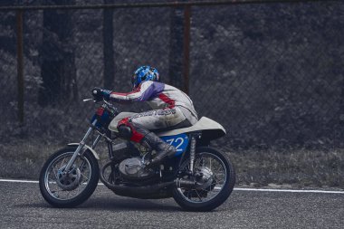 10-05-2021 Lithuania, Kaunas MotoGP rider, Motorcyclist ride in corner. Road in forest.