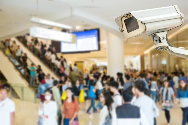 CCTV camera or surveillance operating with crowded people in bac — Stock Photo, Image