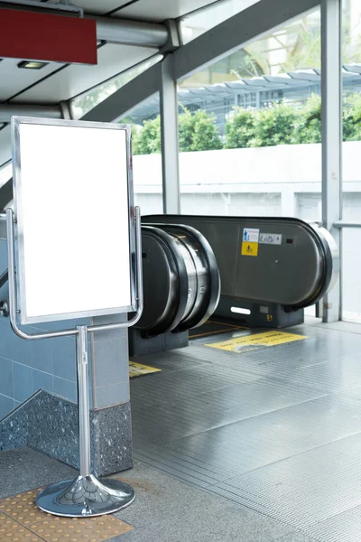 Blank bill board for advertising in front of escalator — Stock Photo, Image