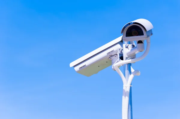 CCTV camera or surveillance operaiting on blue sky — Stock Photo, Image