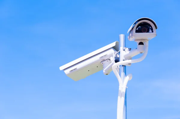 CCTV camera or surveillance operaiting on blue sky — Stock Photo, Image