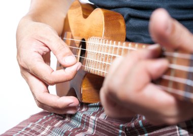 Hand playing ukulele, small string instrument clipart