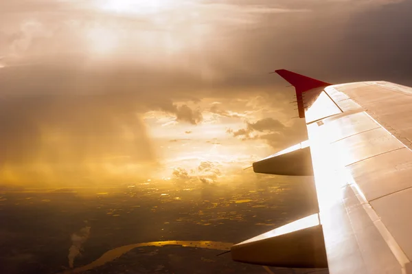 Wing of the plane on golden sky background — Stock Photo, Image