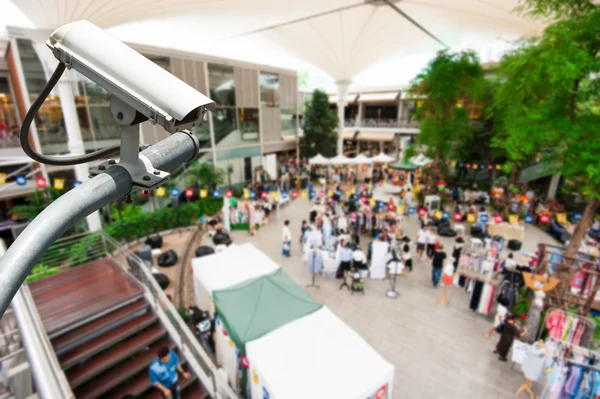 CCTV camera or surveillance operating with crowded people in bac — Stock Photo, Image