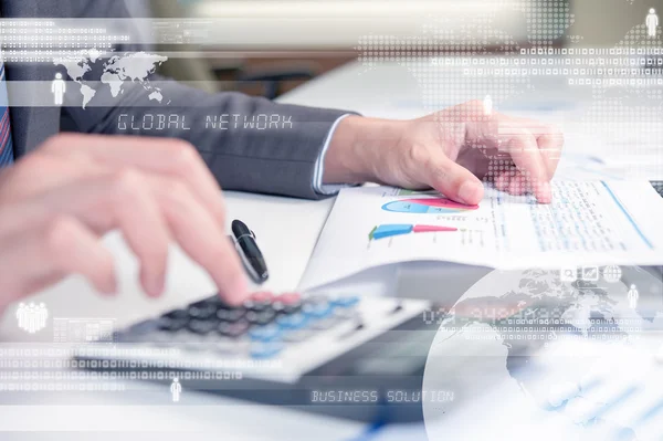 Business person using calculator against technology background — Stock Photo, Image