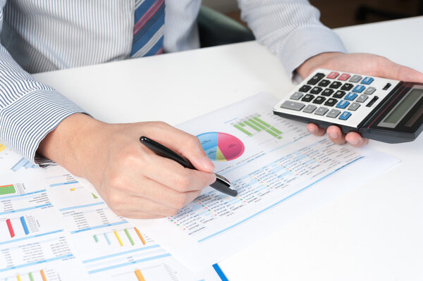 Businessman analyzing report, business performance concept