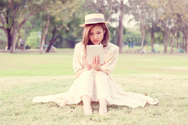 Vintage Girl sit in park listen music via small talk — Stock Photo, Image