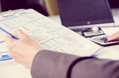 İşadamı hesap makinesi kullanarak analiz raporu