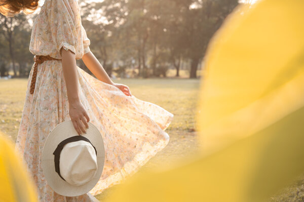 beautiful young woman walk in park with hat