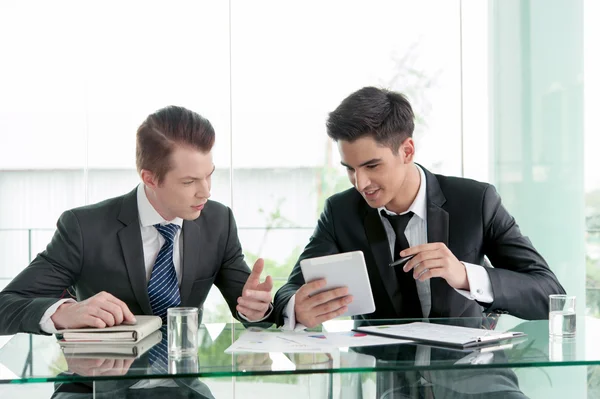 Two businessman using tablet in meeting — Stock Photo, Image