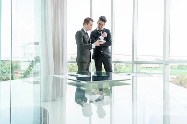 Business partners discussing documents and ideas in office — Stock Photo, Image