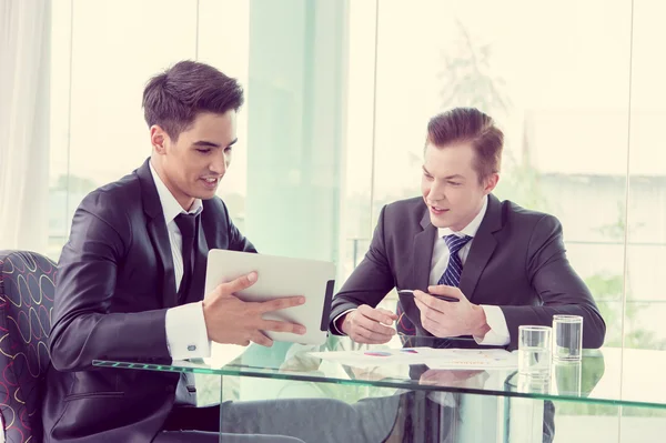 Business partners discussing documents and ideas at meeting — Stock Photo, Image