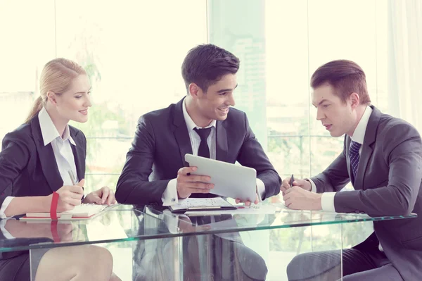 Business partners discussing documents and ideas at meeting — Stock Photo, Image