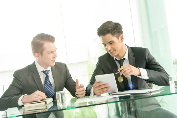 Two businessman using tablet in meeting — Stock Photo, Image