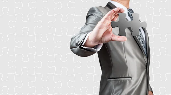 Business man show white jigsaw in hand, conceito de estratégia de negócios — Fotografia de Stock