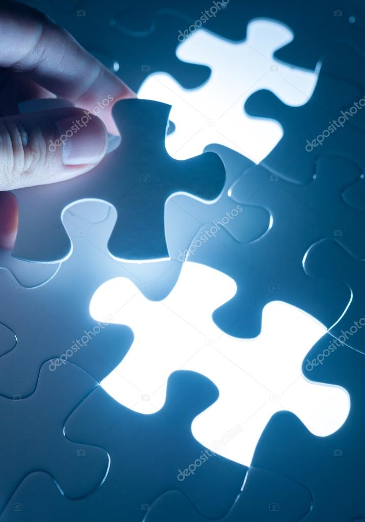 Hand insert jigsaw, conceptual image of business strategy, decis