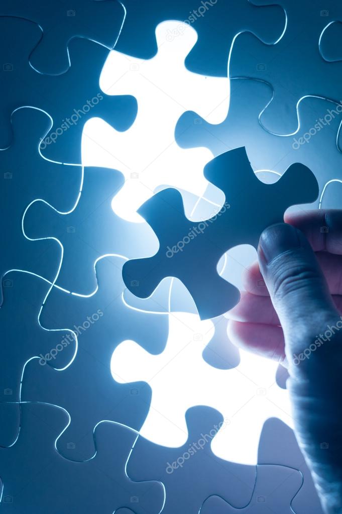 Hand insert jigsaw, conceptual image of business strategy, decis