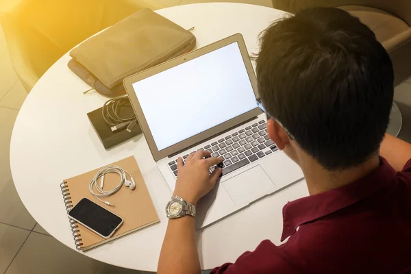 Bijgesneden shot van een jonge man aan het werk vanuit huis met behulp van slimme telefoon — Stockfoto