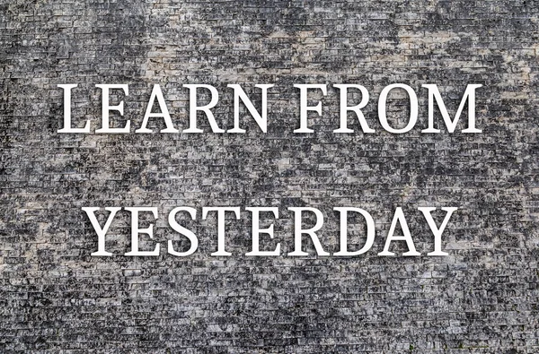 İlham verici motivasyon alıntısı. Dünden öğrenin, taş duvar arkaplanından..