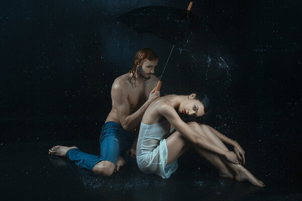 Man and a woman under water drops.