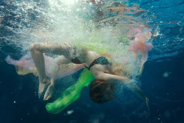 Around girls air bubbles under water. — Stock Photo, Image