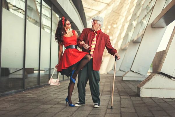 Old man dancing with a young girl.