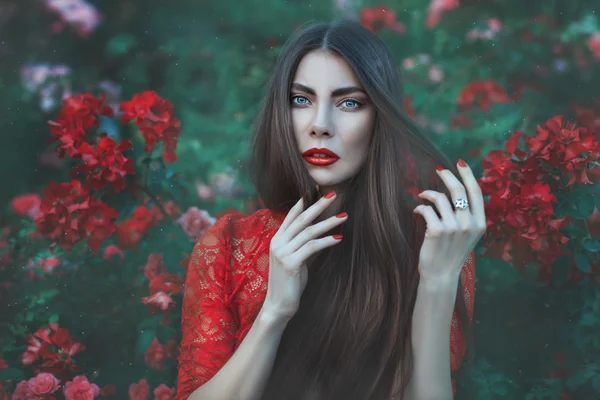 Mujer entre las flores con el pelo largo . — Foto de Stock