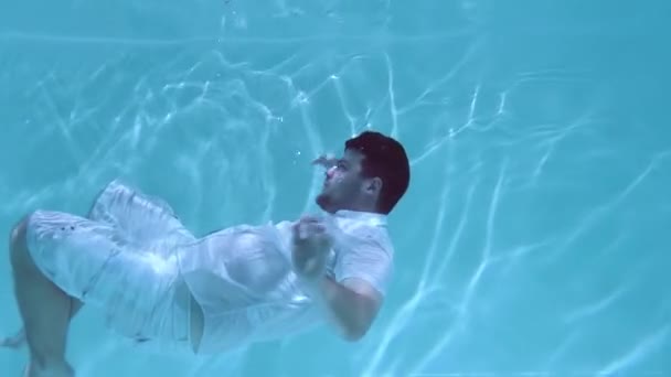 Άντρας Που Φοράει Πουκάμισο Και Σορτς Κολυμπάει Κάτω Από Νερό — Αρχείο Βίντεο