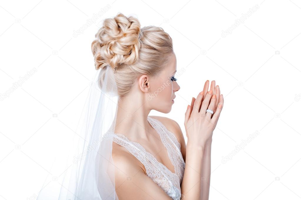 Beautiful bride is standing sideways.