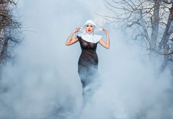 Nun in the smoke. — Stock Photo, Image