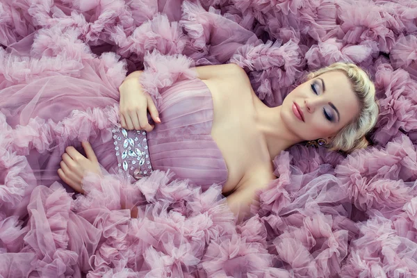 Girl in a pink dress sleeping. — Stock Photo, Image