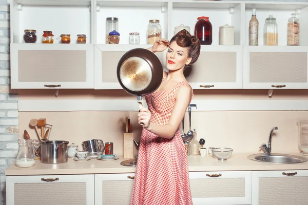 Girl straightens her hair in the kitchen. — Stock Photo, Image