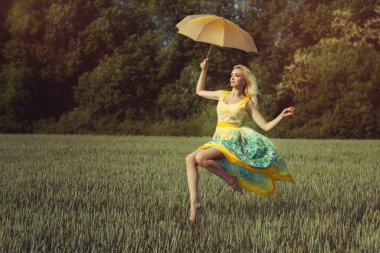 Girl with an umbrella levitates clipart