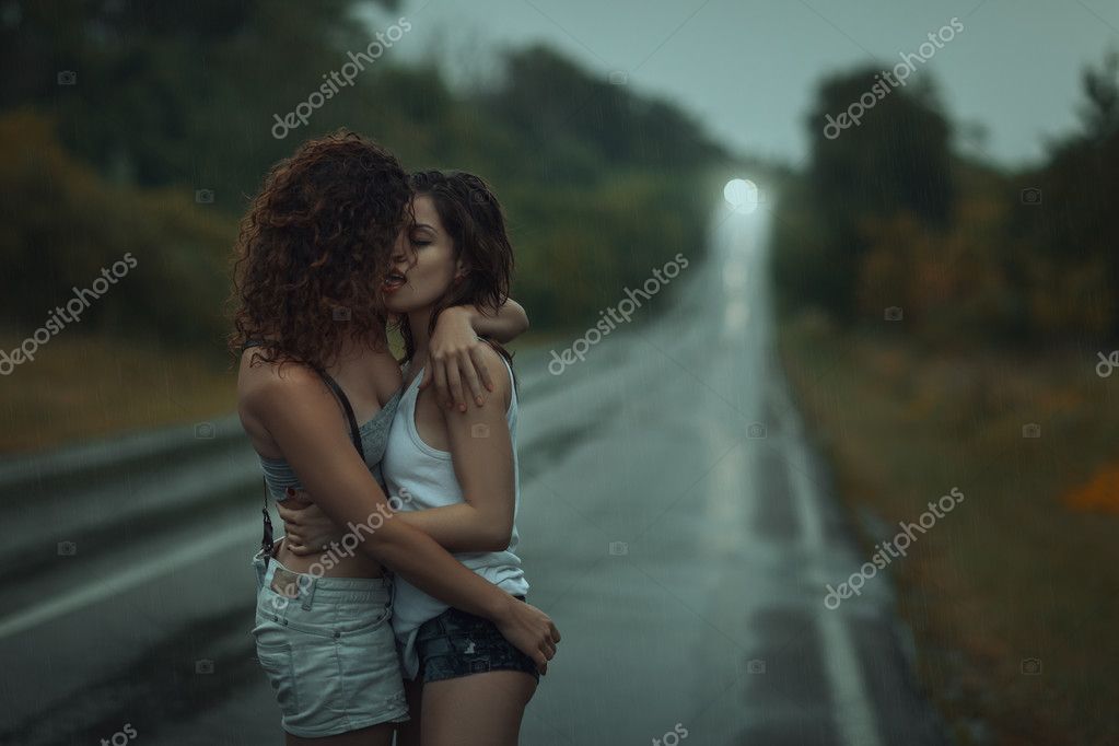 Girls lesbians kissing under the heavy rain. Stock Photo by ©kladyk 79636896