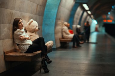 Girl is sad sitting on the bench.