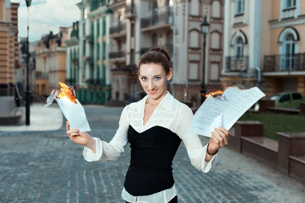 Girl with joy on her face burn documents. — Stock Photo, Image