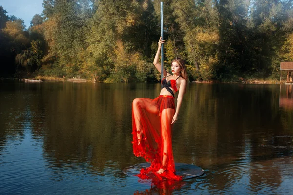 Girl raised her leg  dance, and dancing around  pole dance.