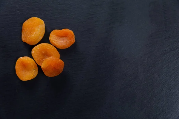 dried apricots. fruit on a stone slab. copy space