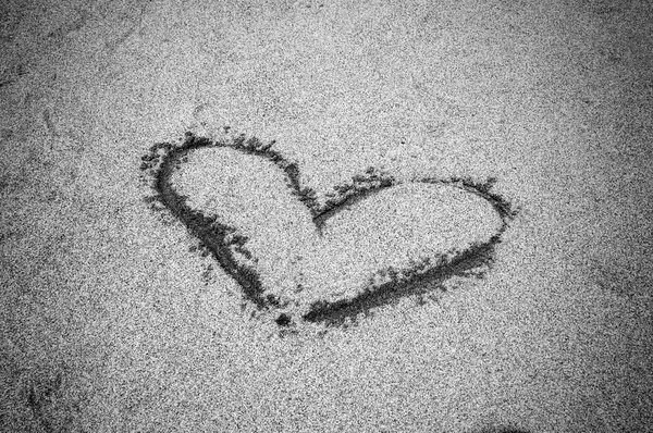 Black and White Heart drawn on sand. Horizontal composition.