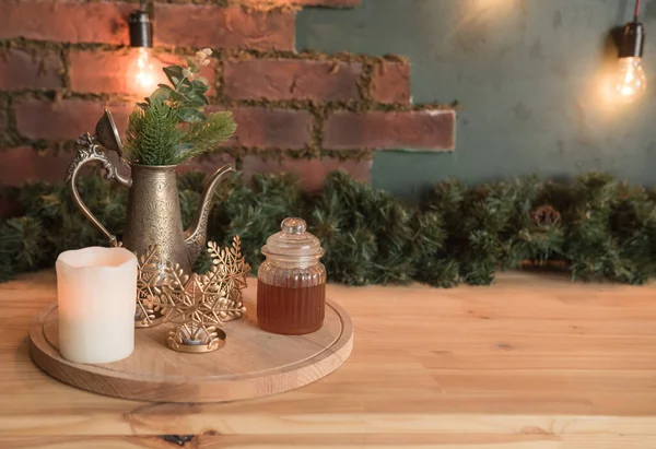 Decor in the studio, in the kitchen. New Year\'s and Christmas. Brick wall, candle, coffee pot. Winter.