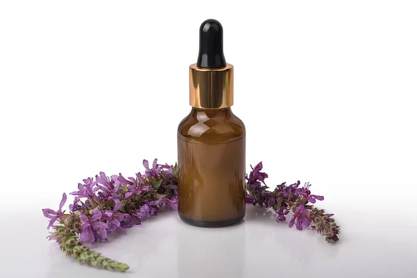Cosmetic lotion in a bottle with lilac flowers. On white background. — Fotografia de Stock