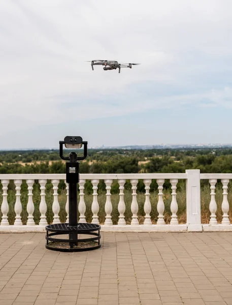 Flying drone over a survey telescope. In the city center on the waterfront. Shooting in the city.