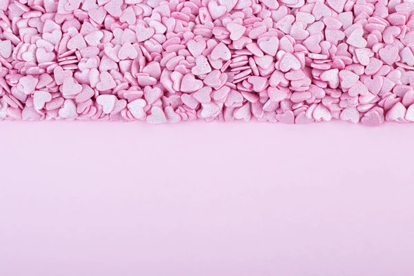 Superficie Rosa Está Cubierta Con Montón Confeti Rosa Forma Corazón —  Fotos de Stock