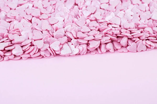 Superficie Rosa Está Cubierta Con Montón Confeti Rosa Forma Corazón —  Fotos de Stock