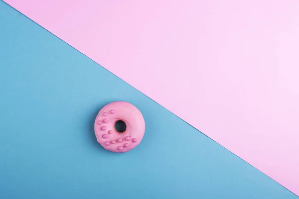 stock image Pink donuts on a blue-pink background, top view with space for text. creative background for holidays