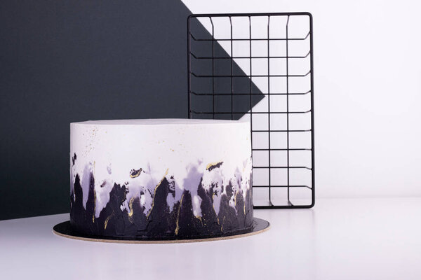 beautiful black and white cake on a white table. cake for a holiday and birthday