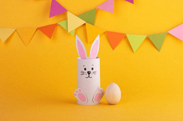 Cute Easter bunny made of paper with Easter eggs, handmade. Happy Easter. Spring Festival