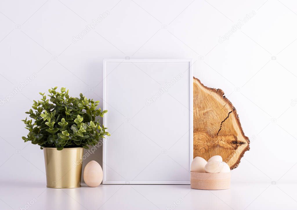 easter background with white text frame and wooden easter eggs on white table. interior easter background