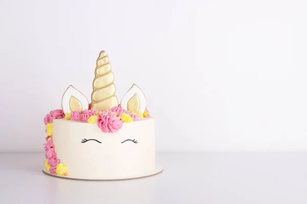beautiful delicate unicorn birthday cake on a white table